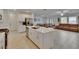 Open-concept kitchen with a large island, stainless steel appliances, and a seamless flow into the living area at 34780 Rainville Loop, Zephyrhills, FL 33541