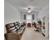 Cozy living space featuring a comfortable black leather sofa and a functional desk area for work or study at 34780 Rainville Loop, Zephyrhills, FL 33541