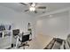Bright living room with tiled floors, a comfortable leather sofa, and a convenient workspace with shelves at 34780 Rainville Loop, Zephyrhills, FL 33541