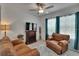 Comfortable living room with ample seating, stylish decor, and a ceiling fan at 34780 Rainville Loop, Zephyrhills, FL 33541