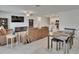 Open concept living area with combined living, dining, and kitchen areas under bright lights at 34780 Rainville Loop, Zephyrhills, FL 33541