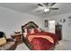 The main bedroom boasts a large bed, side tables, and carpet floors at 34780 Rainville Loop, Zephyrhills, FL 33541