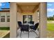 Covered patio featuring stylish outdoor furniture and a view of the backyard and surrounding community at 34780 Rainville Loop, Zephyrhills, FL 33541
