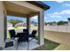 Comfortable covered patio with a table and chairs, ideal for outdoor dining and relaxation at 34780 Rainville Loop, Zephyrhills, FL 33541
