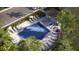 Community swimming pool featuring several lounge chairs, palm trees and nearby parking at 36046 Risa Michele St, Zephyrhills, FL 33541