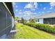Manicured backyard with lush green grass and mature landscaping between homes at 3764 Laughing Dove Ave, Sun City Center, FL 33573