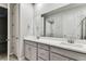 Bathroom featuring a double vanity, and view into the walk-in closet at 3764 Laughing Dove Ave, Sun City Center, FL 33573