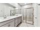 Bathroom featuring a double vanity, frameless shower, and neutral finishes at 3764 Laughing Dove Ave, Sun City Center, FL 33573