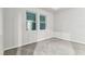 Empty bedroom with carpet flooring, two windows, and light gray walls at 3764 Laughing Dove Ave, Sun City Center, FL 33573