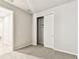 Bright bedroom featuring a closet with sliding doors and neutral-colored walls and carpet at 3764 Laughing Dove Ave, Sun City Center, FL 33573