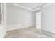 Empty bedroom with carpet, gray walls, and a view of the entry to the on-suite bathroom at 3764 Laughing Dove Ave, Sun City Center, FL 33573
