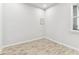 Bright bedroom features neutral walls and floors, with a window providing natural light at 3764 Laughing Dove Ave, Sun City Center, FL 33573