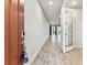Bright entryway features wood-look tile flooring and a glimpse into the rest of the home at 3764 Laughing Dove Ave, Sun City Center, FL 33573