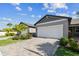 Inviting home features a lush, manicured lawn and a pristine two-car garage with paver driveway at 3764 Laughing Dove Ave, Sun City Center, FL 33573