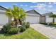 Inviting home features a lush, manicured lawn and a pristine two-car garage with paver driveway at 3764 Laughing Dove Ave, Sun City Center, FL 33573