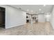 Open concept living space featuring wood-look tile flooring and a modern kitchen with stainless steel appliances at 3764 Laughing Dove Ave, Sun City Center, FL 33573