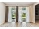 Spacious living room featuring tile floors and sliding glass doors that open to the outdoors at 3764 Laughing Dove Ave, Sun City Center, FL 33573