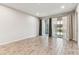 Bright living room featuring wood-look tile flooring and sliding glass doors that open to the outside at 3764 Laughing Dove Ave, Sun City Center, FL 33573