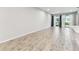 Open-concept living room with sliding glass doors and wood-style tile flooring for a modern touch at 3764 Laughing Dove Ave, Sun City Center, FL 33573