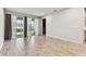 Bright living room with wood-look tile flooring and sliding glass doors to the backyard at 3764 Laughing Dove Ave, Sun City Center, FL 33573