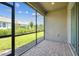Enjoy this screened lanai with brick flooring overlooking the backyard and blue sky at 3764 Laughing Dove Ave, Sun City Center, FL 33573