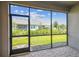Relaxing screened patio with brick pavers and a view of the lush green lawn and landscaping at 3764 Laughing Dove Ave, Sun City Center, FL 33573