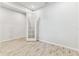 Bright room with wood-look tile flooring, white walls, and natural light from French doors at 3764 Laughing Dove Ave, Sun City Center, FL 33573