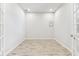Bright room with wood-look tile flooring, white walls, and natural light from French doors at 3764 Laughing Dove Ave, Sun City Center, FL 33573