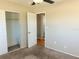 Bedroom featuring carpet floors, ceiling fan, open door to the bathroom and a closet at 3851 72Nd N St, St Petersburg, FL 33709