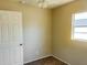 Neutral-toned bedroom features cozy carpet, ceiling fan, and bright natural light from a window at 3851 72Nd N St, St Petersburg, FL 33709