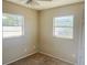 Small bedroom featuring two bright windows and carpet floors at 3851 72Nd N St, St Petersburg, FL 33709