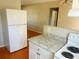 Open kitchen featuring neutral wall color, white cabinetry and wood-look flooring at 3851 72Nd N St, St Petersburg, FL 33709