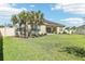 This backyard provides a serene retreat with a well-kept lawn, decorative potted plants, and privacy fencing at 3952 Bonfire Dr, Odessa, FL 33556