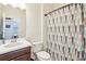 Cozy bathroom features a sink and a shower with a colorful curtain at 3952 Bonfire Dr, Odessa, FL 33556