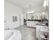 Bright bathroom with tiled floor, soaking tub, and double vanity sink at 3952 Bonfire Dr, Odessa, FL 33556