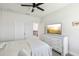 Bedroom offers a ceiling fan, mounted TV, and dresser with a view at 3952 Bonfire Dr, Odessa, FL 33556