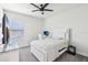 This bright bedroom features a ceiling fan, comfortable bed, and modern decor at 3952 Bonfire Dr, Odessa, FL 33556