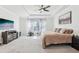 Bedroom featuring ceiling fan, window, carpet, and closet; perfect for relaxation and rest at 3952 Bonfire Dr, Odessa, FL 33556