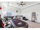 Large bonus room with fun activities, comfortable seating, ceiling fan and natural light from the window at 3952 Bonfire Dr, Odessa, FL 33556