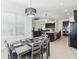 Open-concept dining area flowing into a modern kitchen and living space at 3952 Bonfire Dr, Odessa, FL 33556
