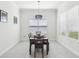 Cozy dining room with modern lighting, a set table, and bright window views at 3952 Bonfire Dr, Odessa, FL 33556