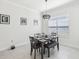 Bright dining area with a modern light fixture, table setting, and a bench seat at 3952 Bonfire Dr, Odessa, FL 33556