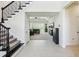 Open foyer with staircase, tile flooring, and a view into the spacious living room at 3952 Bonfire Dr, Odessa, FL 33556