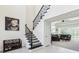 Elegant foyer with a staircase and open layout leading to the living area, creating a seamless flow at 3952 Bonfire Dr, Odessa, FL 33556