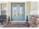 Inviting front entry with double doors, stylish decor, and a 'happy place' doormat at 3952 Bonfire Dr, Odessa, FL 33556