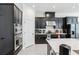Well-appointed kitchen with stainless steel appliances, sleek dark cabinets, and modern countertops at 3952 Bonfire Dr, Odessa, FL 33556