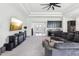 Open living space with built-in bar area, tile floors, and dark modular sofa at 3952 Bonfire Dr, Odessa, FL 33556