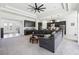 Open-concept living room with a large sectional, modern lighting, and views into the kitchen and dining spaces at 3952 Bonfire Dr, Odessa, FL 33556