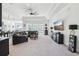 Bright living room with plush seating, a ceiling fan, and sliding glass doors to the yard at 3952 Bonfire Dr, Odessa, FL 33556