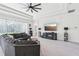 Bright living room features a ceiling fan, a large window, and a fireplace with mounted television at 3952 Bonfire Dr, Odessa, FL 33556